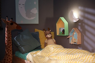 Photo of Crescent shaped night lamp on wall in child's room