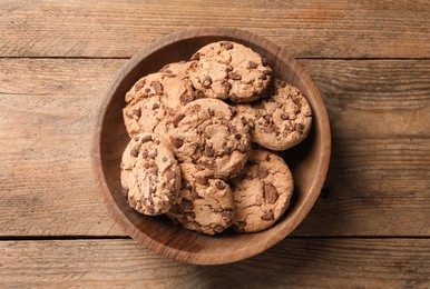 Photo of Delicious chocolate chip cookies on wooden table, top view