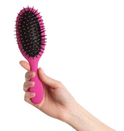 Photo of Woman holding hair brush against white background, closeup