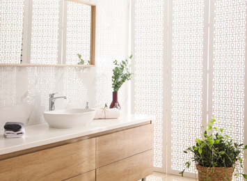 Stylish bathroom interior with countertop, mirror and plants. Design idea