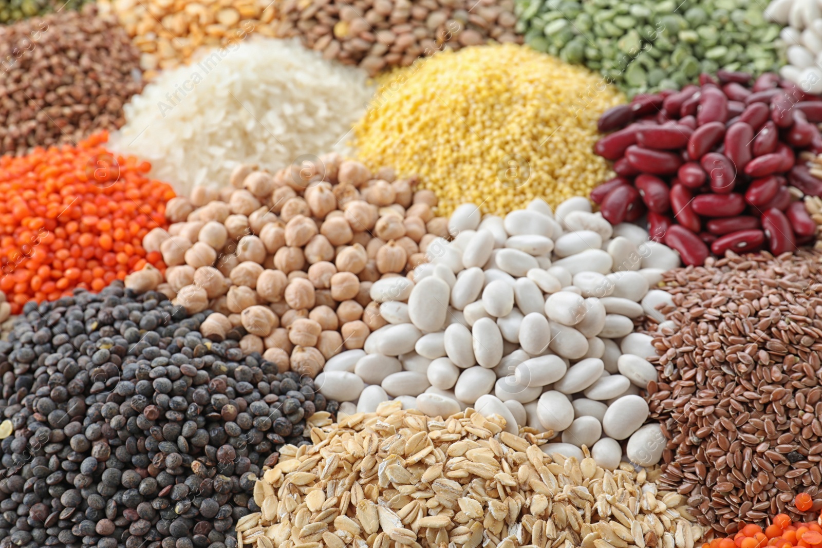 Photo of Different types of legumes and cereals as background, closeup. Organic grains