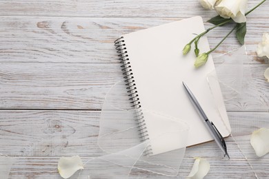 Photo of Guest list. Notebook, pen, rose flowers and ribbon on wooden background, flat lay. Space for text