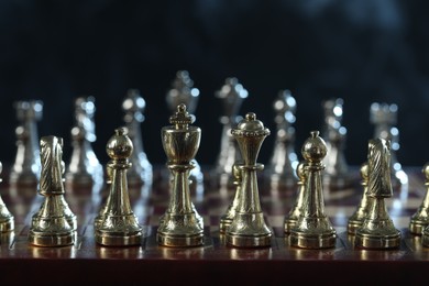 Photo of Set of chess pieces on checkerboard before game, selective focus