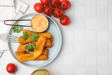 Photo of Tasty fried mozzarella sticks served with sauce on white tiled table, flat lay. Space for text