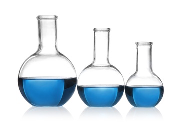Photo of Florence flasks with blue liquid isolated on white. Laboratory glassware