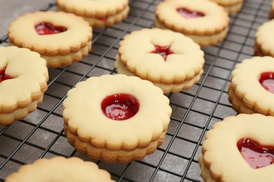 Photo of Traditional Christmas Linzer cookies with sweet jam on cooling rack