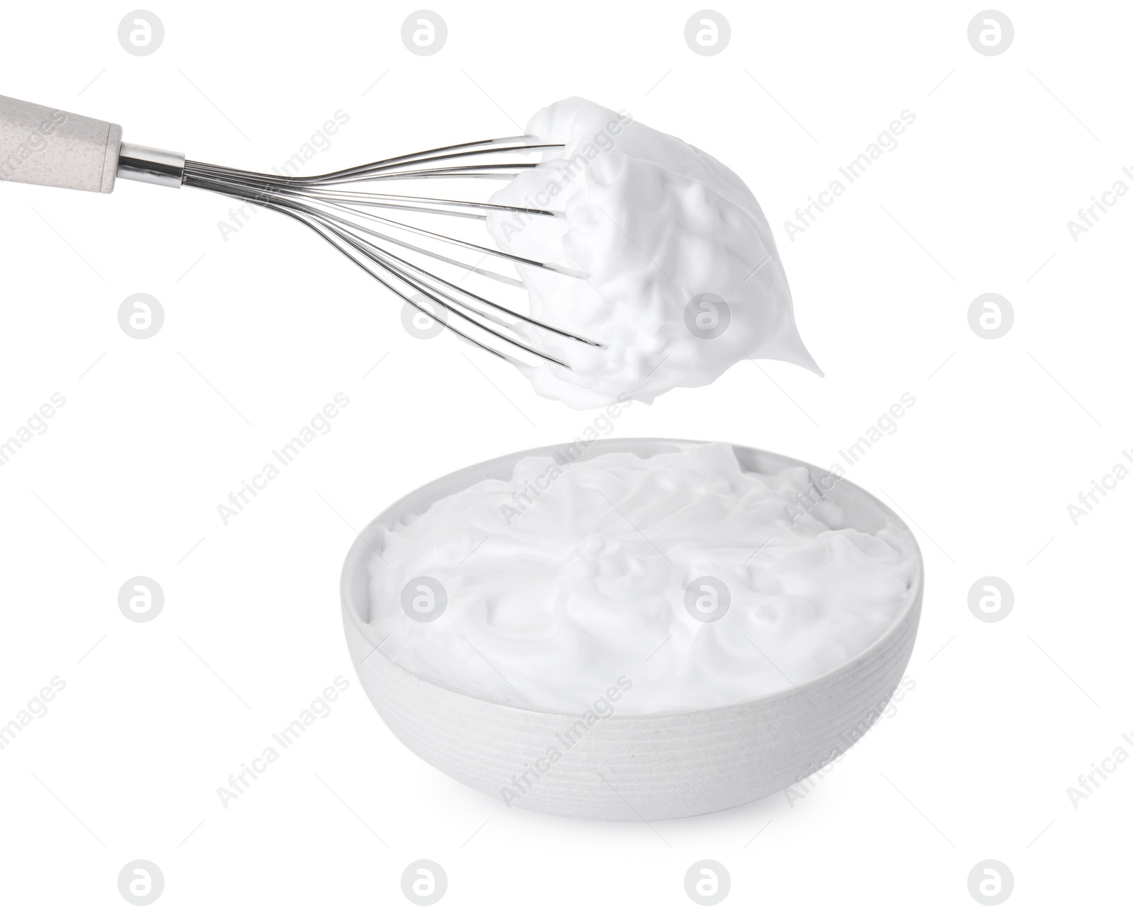 Photo of Bowl and whisk with whipped cream isolated on white