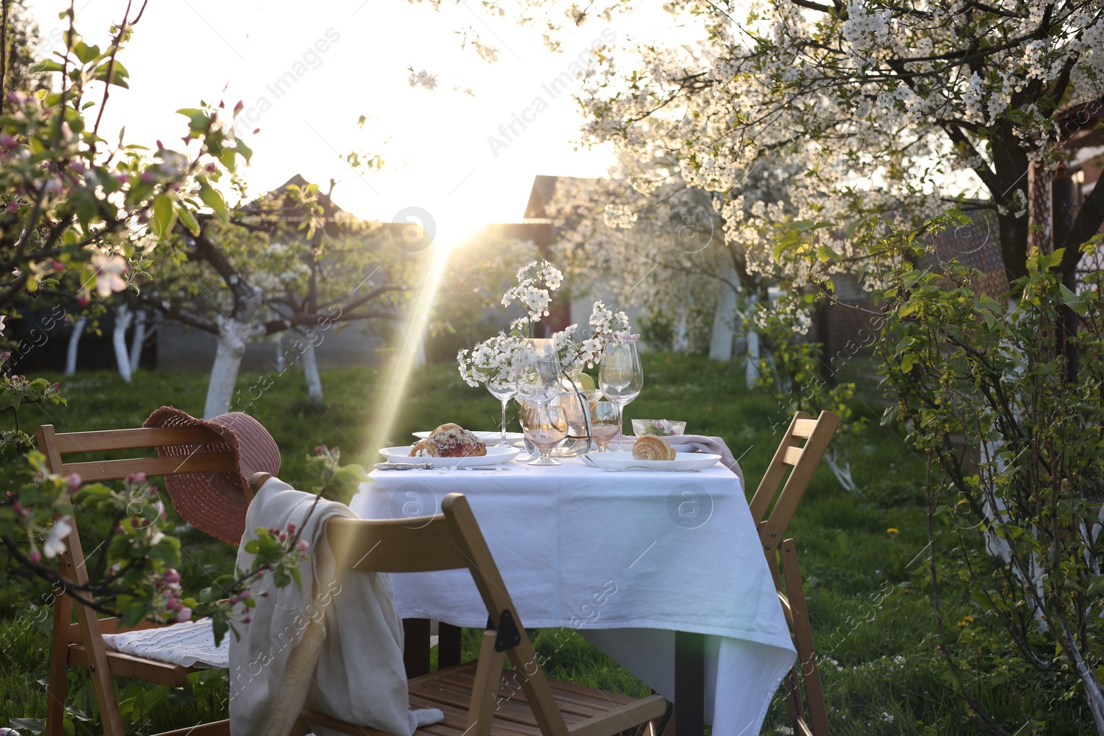 Photo of Stylish table setting with beautiful spring flowers in garden