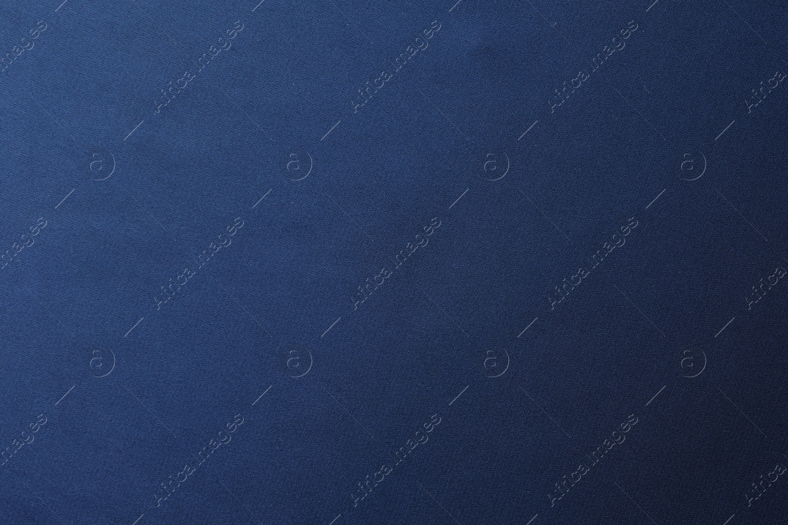 Photo of Texture of blue silk fabric as background, top view