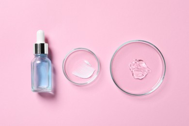Photo of Bottle of cosmetic serum and petri dishes with samples on pink background, flat lay
