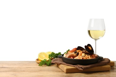 Delicious spaghetti with seafood served on wooden table against white background