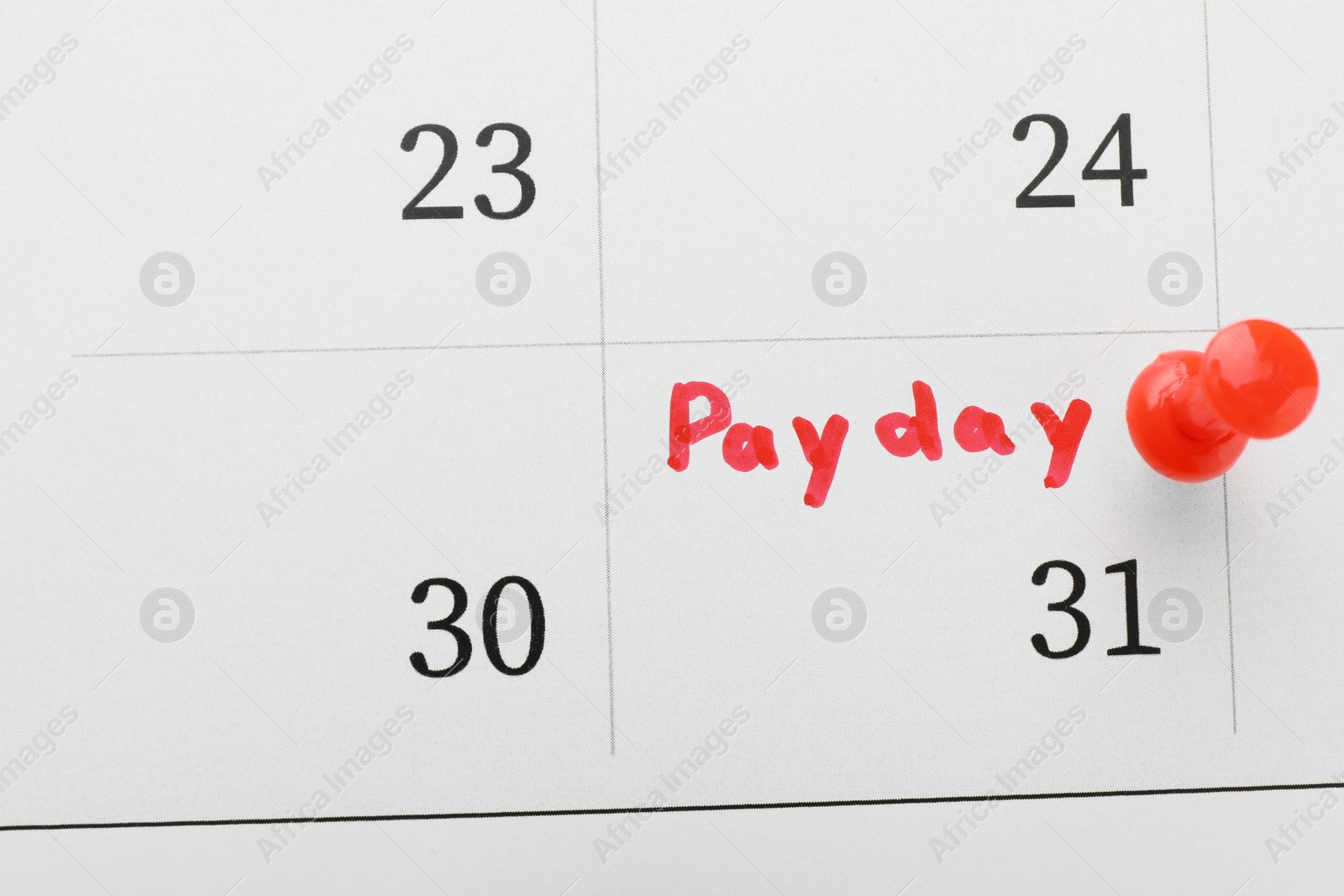 Photo of Calendar page with red pin on payday date, top view