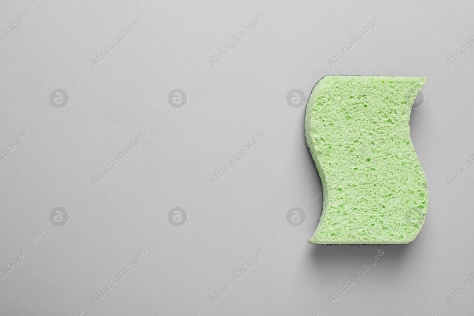 Photo of New sponge on light grey background, top view. Space for text