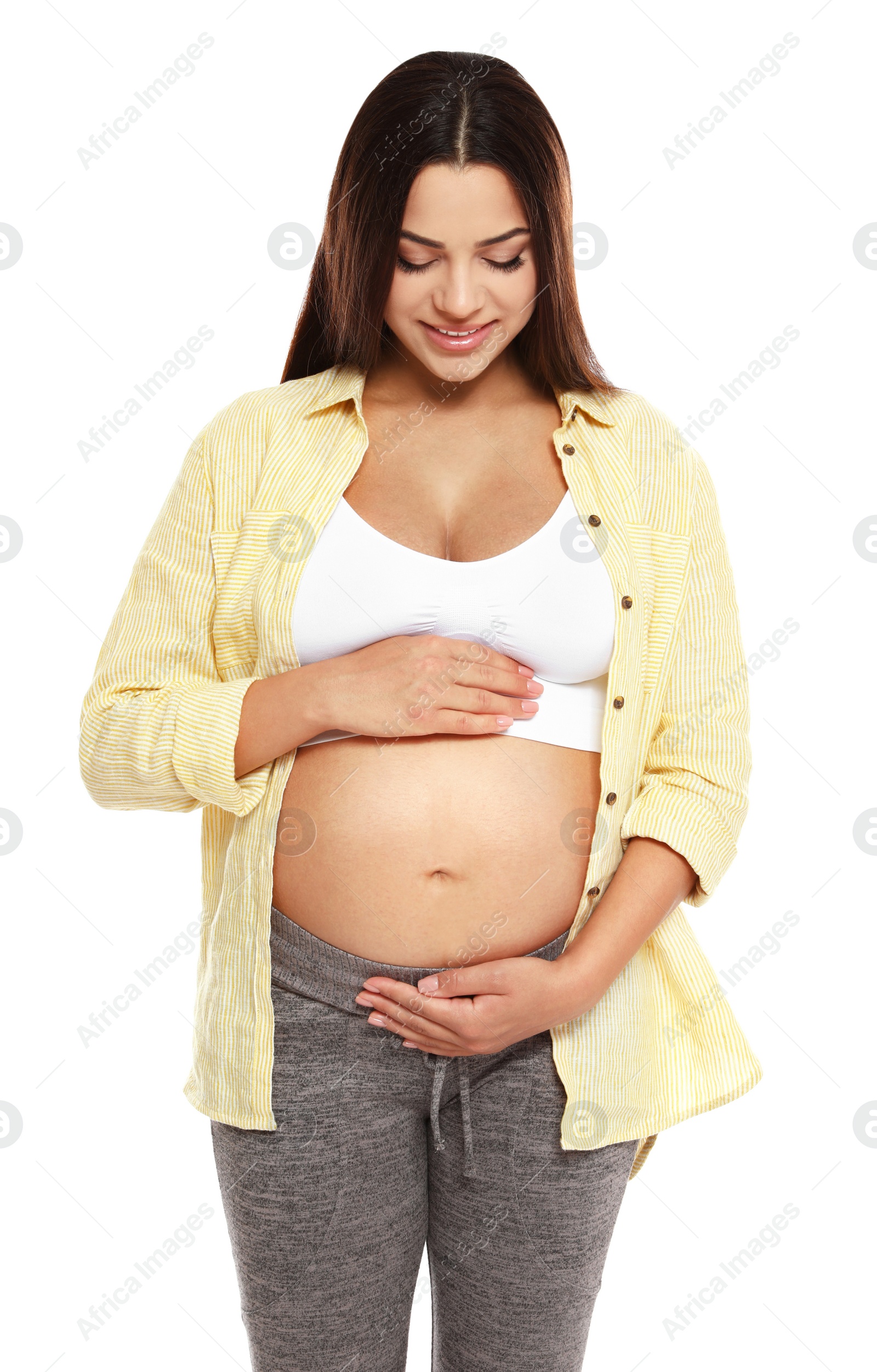 Photo of Portrait of beautiful young pregnant woman in shirt on white background