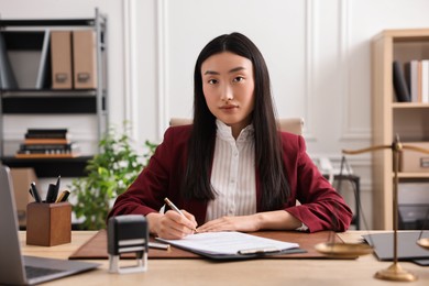 Portrait of notary at table in office