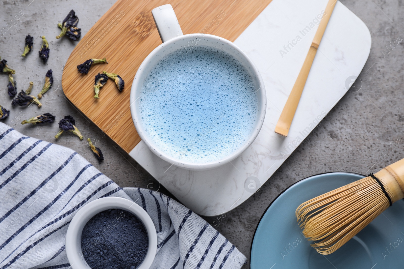 Image of Flat lay composition with blue matcha latte on grey table