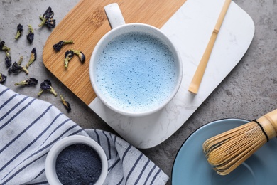 Image of Flat lay composition with blue matcha latte on grey table