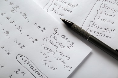 Photo of Sheets of paper with different mathematical formulas and pen, above view