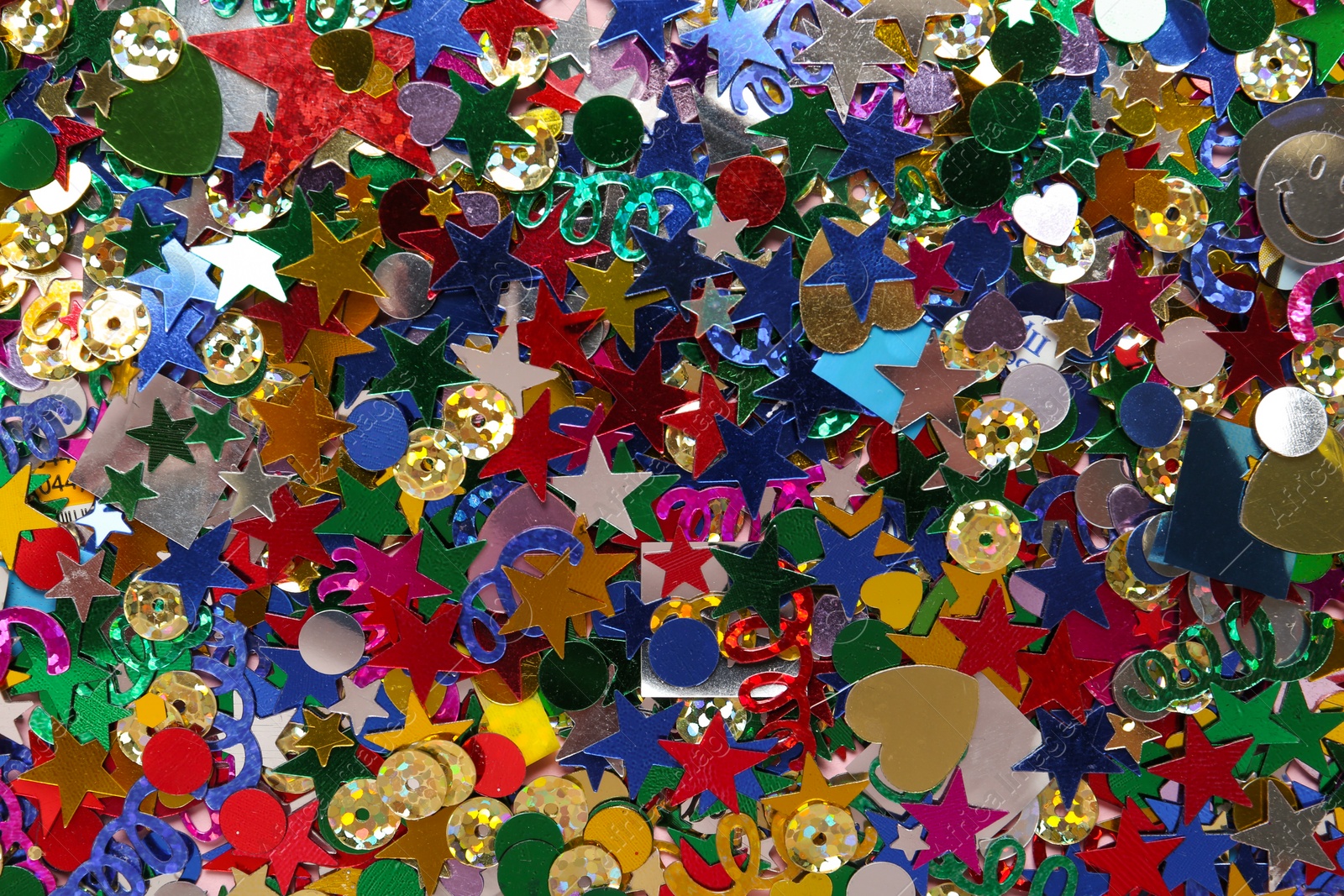 Photo of Bright colorful confetti as background, top view