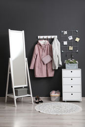 Hallway interior with stylish furniture, clothes and accessories
