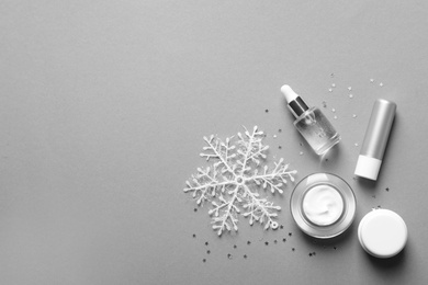Photo of Set of cosmetic products on gray background, flat lay. Winter care