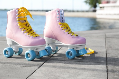 Stylish vintage roller skates on city embankment