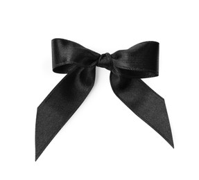 Black satin ribbon tied in bow on white background, top view