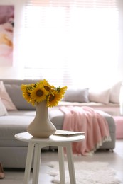 Photo of Beautiful bouquet of sunflowers in vase on white table indoors. Space for text