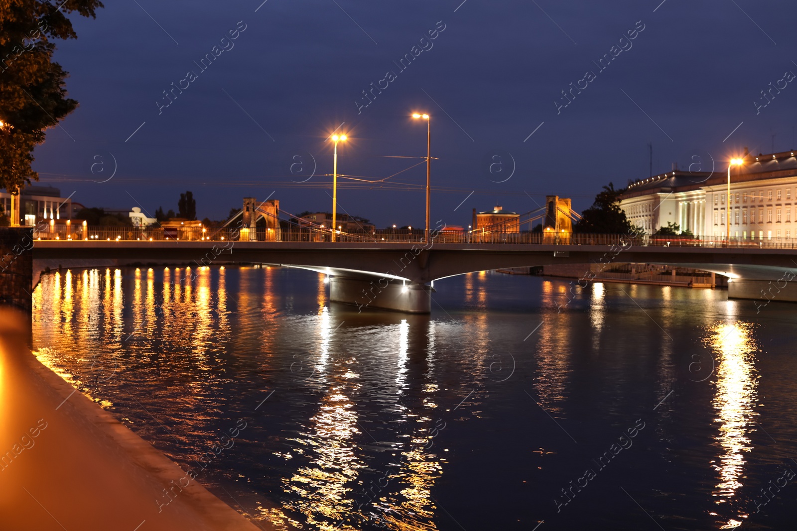 Photo of Beautiful view of illuminated city near river at night