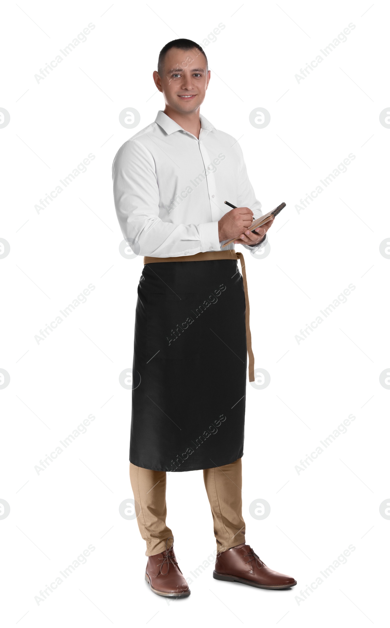 Photo of Full length portrait of happy young waiter with notebook on white background