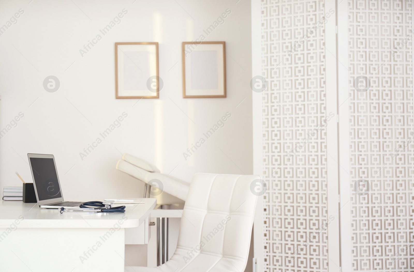 Photo of Doctor's workplace with modern laptop in medical office