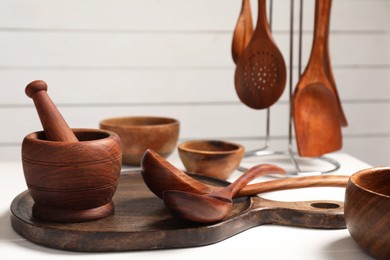 Set of different kitchen utensils on white table