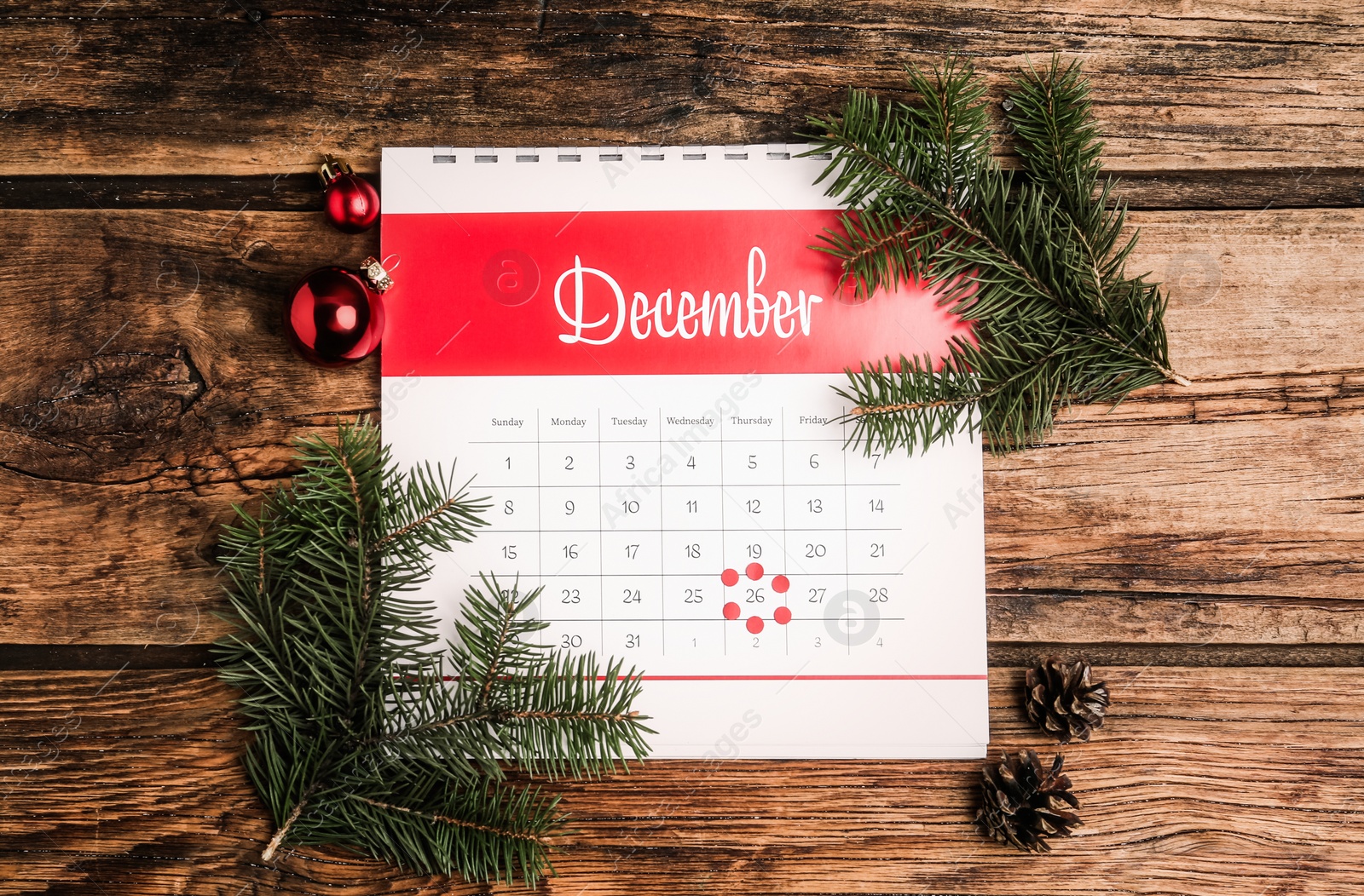 Photo of Flat lay composition with calendar and festive decor on wooden table. Boxing day