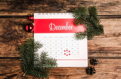 Photo of Flat lay composition with calendar and festive decor on wooden table. Boxing day