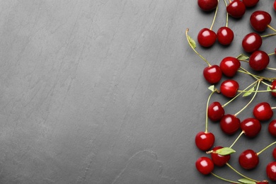 Photo of Delicious cherries on grey background, flat lay