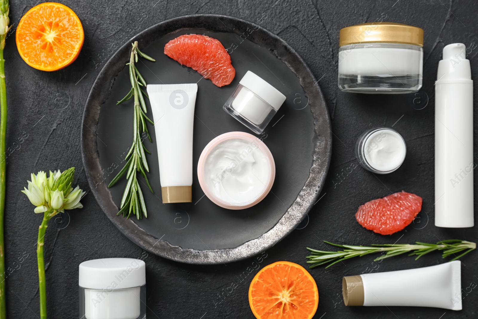 Photo of Beautiful composition with cosmetics on dark background, flat lay