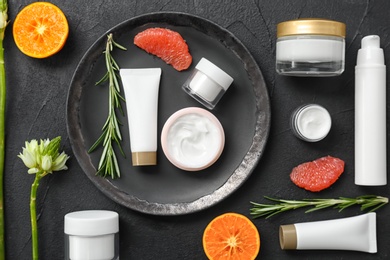 Beautiful composition with cosmetics on dark background, flat lay