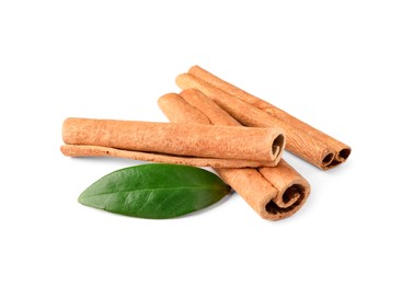 Photo of Cinnamon sticks and green leaf isolated on white