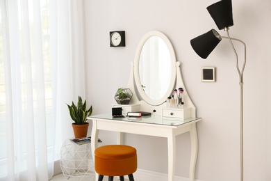 Dressing table with mirror in stylish room interior