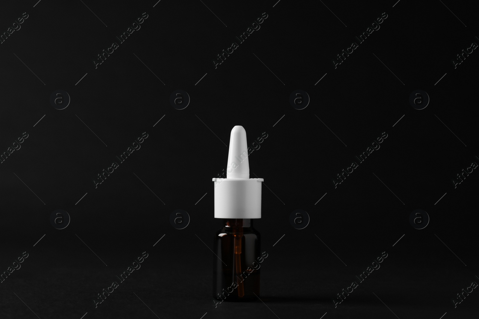 Photo of Bottle of nasal spray on black background