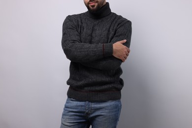 Man in stylish sweater on white background, closeup