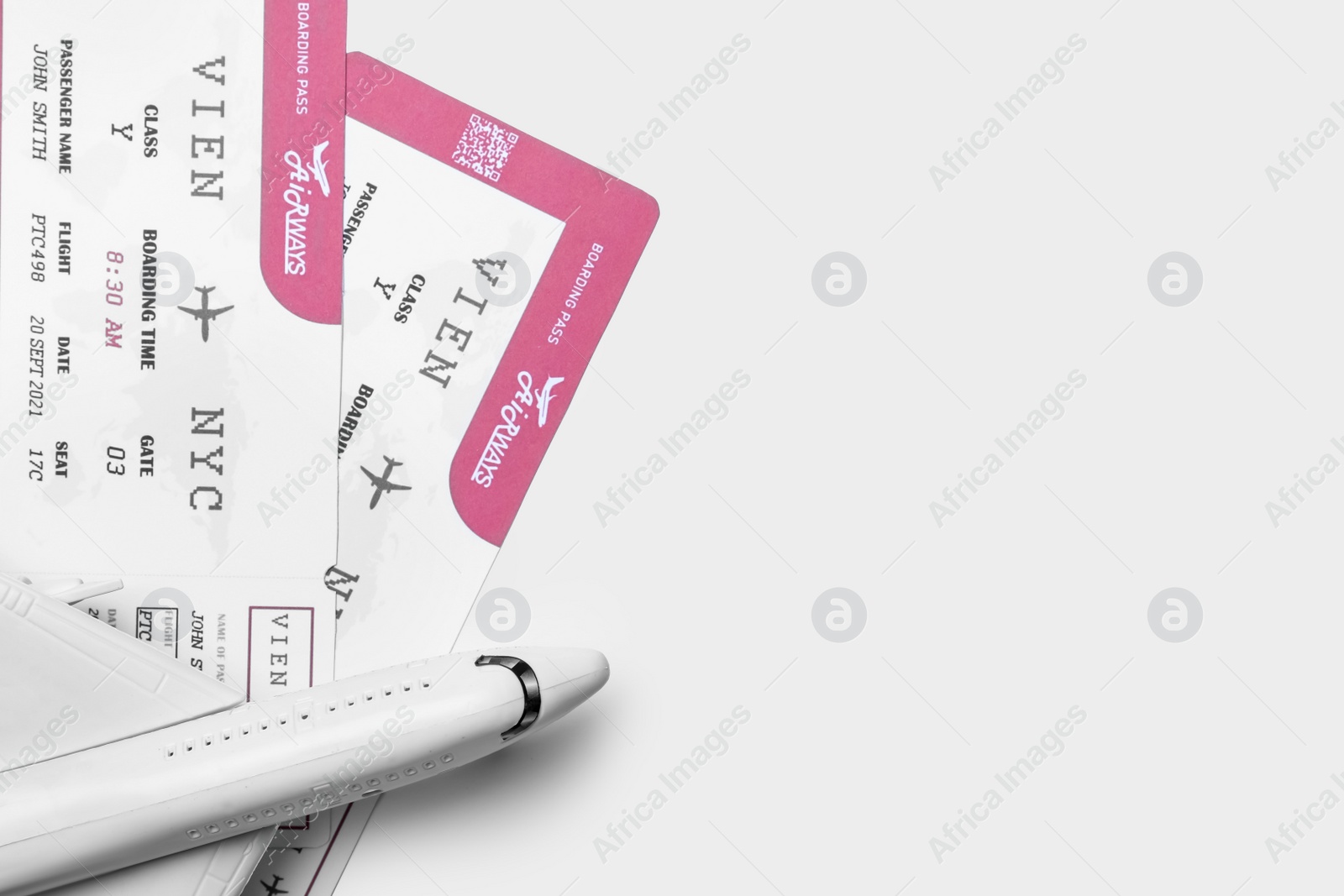 Photo of Toy airplane and tickets on white background, flat lay with space for text. Travel agency concept