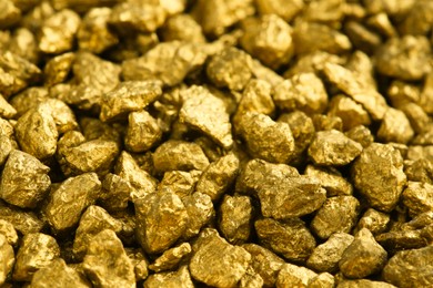 Photo of Many shiny gold nuggets as background, closeup