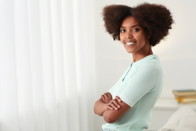Photo of Portrait of smiling African American woman at home. Space for text