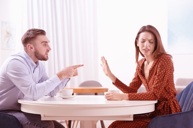 Couple having quarrel in cafe. Cheating and breakup