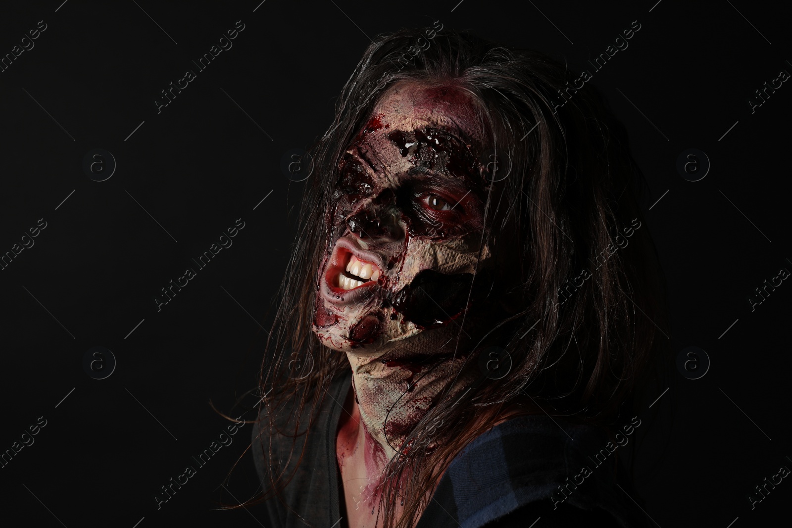 Photo of Scary zombie on dark background. Halloween monster