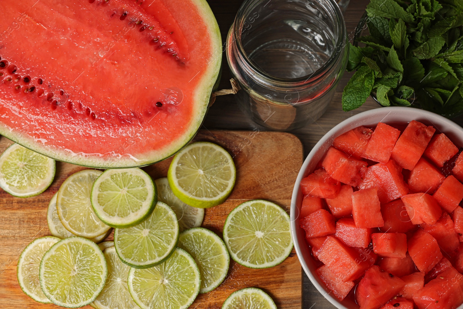 Photo of Fresh ingredients for making watermelon drink with lime on wooden table, above view