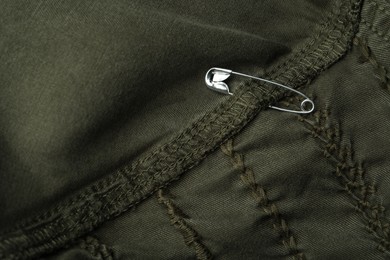 Top view of metal safety pin on clothing