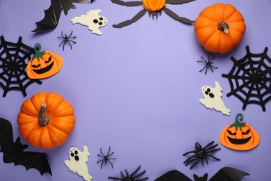 Photo of Frame made of bats, pumpkins, ghosts and spiders on purple background, space for text. Halloween celebration