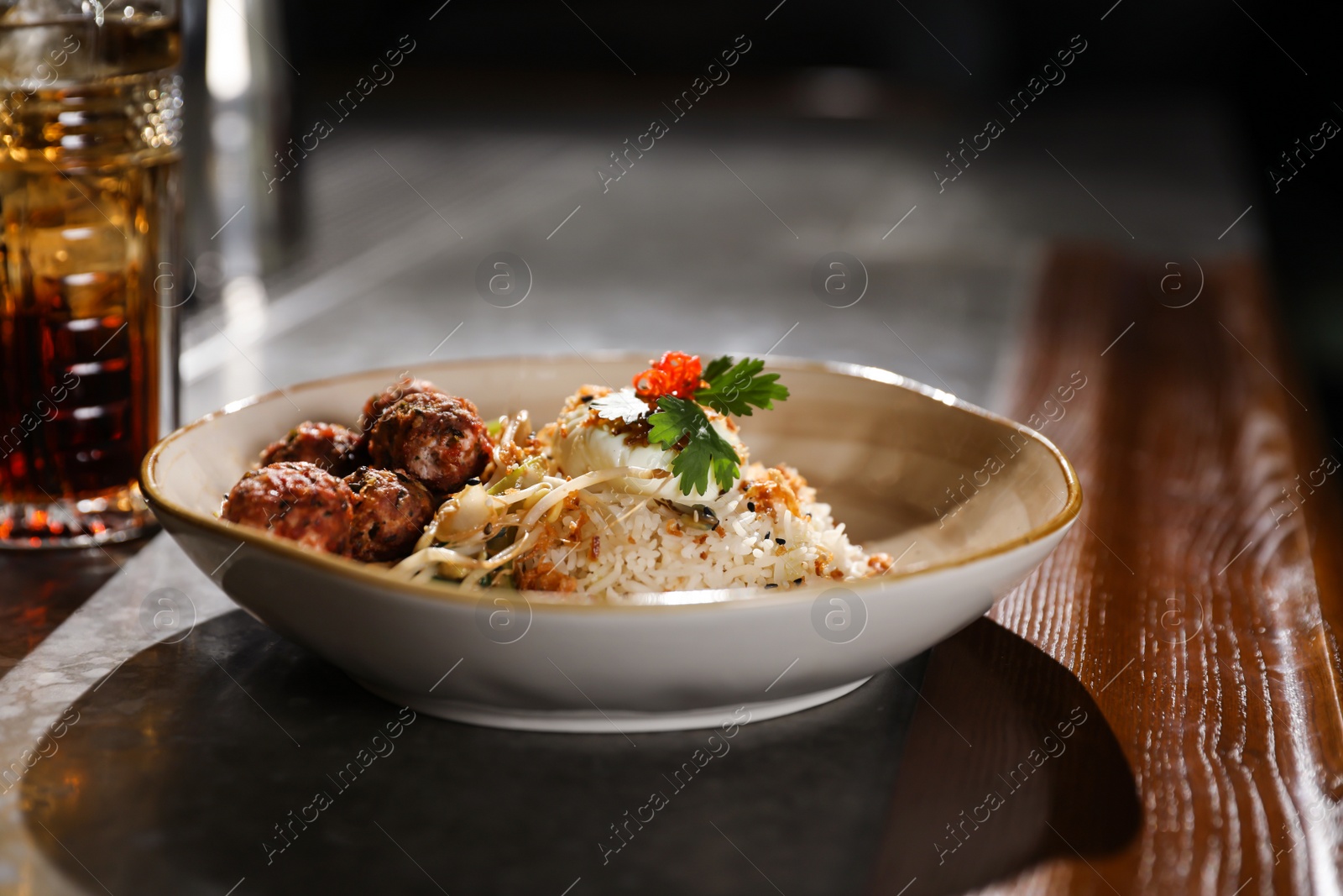 Photo of Plate with rice and meat balls served on table